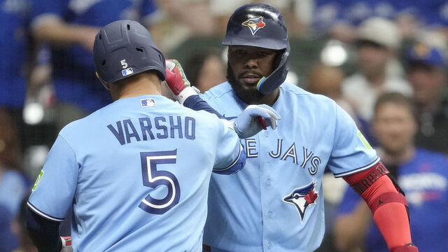 MILWAUKEE, WISCONSIN - APRIL 14: Daulton Varsho #5 of the Toronto Blue Jays celebrates with Vladimir Guerrero Jr. #27 after hitting a solo home run against the Milwaukee Brewers during the sixth inning at American Family Field on April 14, 2026 in Milwaukee, Wisconsin.