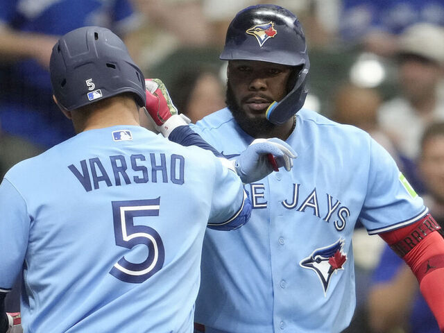 MILWAUKEE, WISCONSIN - APRIL 14: Daulton Varsho #5 of the Toronto Blue Jays celebrates with Vladimir Guerrero Jr. #27 after hitting a solo home run against the Milwaukee Brewers during the sixth inning at American Family Field on April 14, 2026 in Milwaukee, Wisconsin.