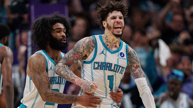 CHARLOTTE, NORTH CAROLINA - APRIL 14: LaMelo Ball #1 celebrates with Coby White #3 of the Charlotte Hornets in overtime against the Miami Heat during their game at Spectrum Center on April 14, 2026 in Charlotte, North Carolina.