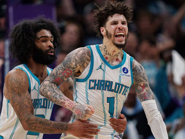 CHARLOTTE, NORTH CAROLINA - APRIL 14: LaMelo Ball #1 celebrates with Coby White #3 of the Charlotte Hornets in overtime against the Miami Heat during their game at Spectrum Center on April 14, 2026 in Charlotte, North Carolina.