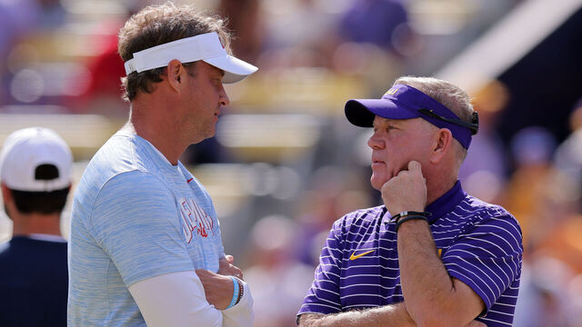 BATON ROUGE, LOUISIANA - OCTOBER 22: Head coach Brian Kelly of the LSU Tigers and head coach Lane Kiffin of the Mississippi Rebels talk before a game at Tiger Stadium on October 22, 2022 in Baton Rouge, Louisiana.