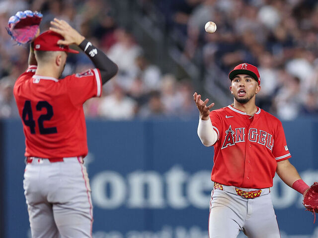 NEW YORK, NEW YORK - APRIL 15: Oswald Peraza #2 and Zach Neto #9 of the Los Angeles Angels react after allowing a pop up to fall in the infield during the ninth inning of the game against the New York Yankees at Yankee Stadium on April 15, 2026 in New York City. All players are wearing the number 42 in honor of Jackie Robinson Day.