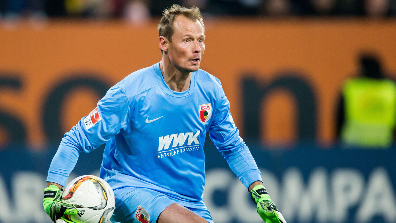 AUGSBURG, GERMANY - MARCH 20: Goalkeeper Alexander Manninger of Augsburg makes a save during the Bundesliga match between FC Augsburg and Borussia Dortmund at SGL Arena on March 20, 2016 in Augsburg, Germany.