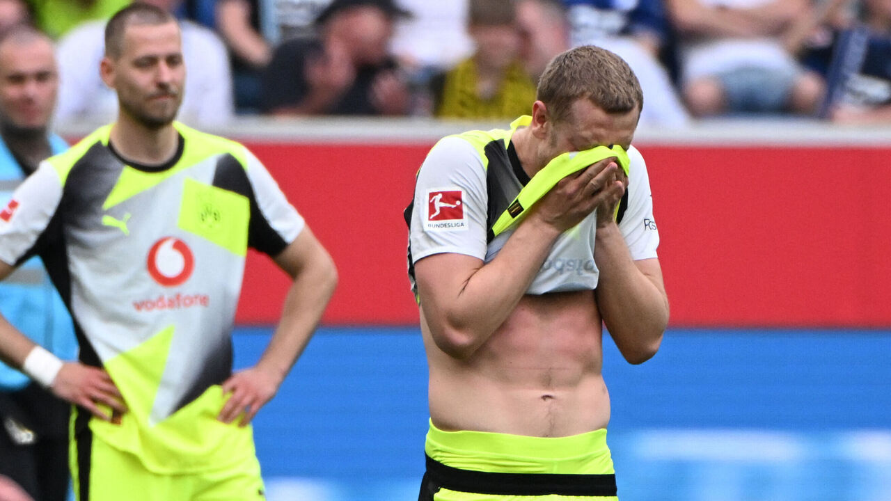 Dortmund's Norwegian defender #26 Julian Ryerson wipes his face after the German first division Bundesliga football match between TSG 1899 Hoffenheim and BVB Borussia Dortmund in Sinsheim, southwestern Germany on April 18, 2026. / DFL REGULATIONS PROHIBIT ANY USE OF PHOTOGRAPHS AS IMAGE SEQUENCES AND/OR QUASI-VIDEO