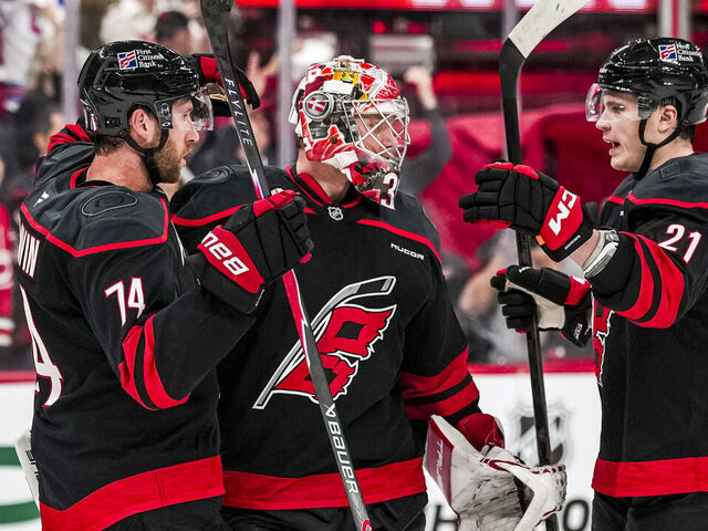 RALEIGH, NORTH CAROLINA - APRIL 18: Jaccob Slavin #74, Frederik Andersen #31, and Alexander Nikishin #21 of the Carolina Hurricanes celebrate on the ice after winning Game One of the First Round of the 2026 Stanley Cup Playoffs against the Ottawa Senators at Lenovo Center on April 18, 2026 in Raleigh, North Carolina.