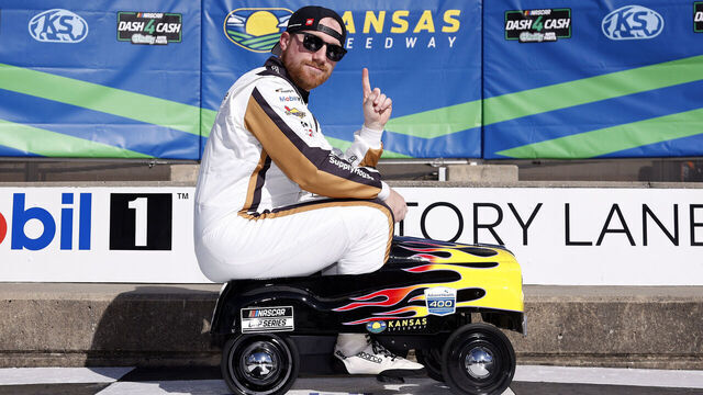 KANSAS CITY, KANSAS - APRIL 18: Tyler Reddick, driver of the #45 Supply House Toyota, poses on a toy car for photos after winning the pole award during qualifying for the NASCAR Cup Series AdventHealth 400 at Kansas Speedway on April 18, 2026 in Kansas City, Kansas.