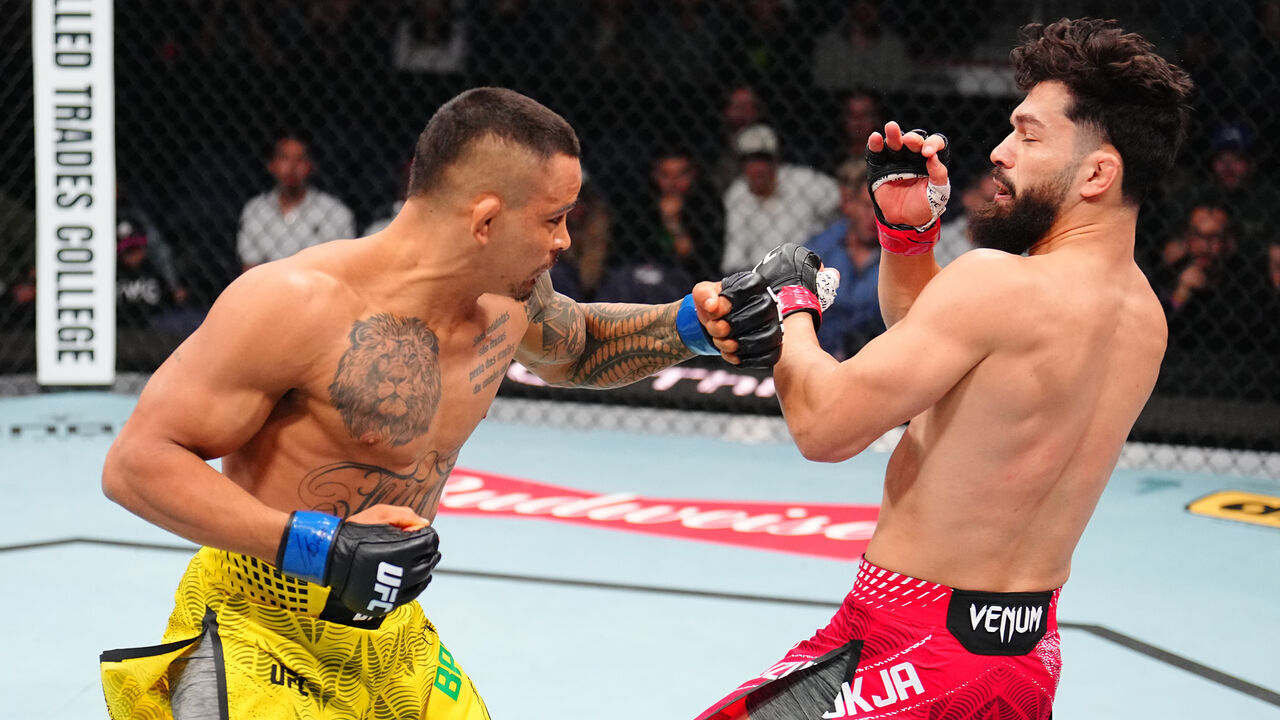 WINNIPEG, MANITOBA - APRIL 18: (L-R) Marcio Barbosa of Brazil knocks out Dennis Buzukja in a featherweight fight during the UFC Fight Night event at Canada Life Centre on April 18, 2026 in Winnipeg, Manitoba.