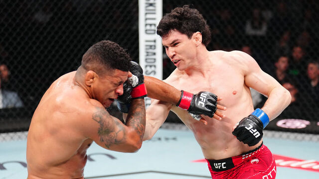 WINNIPEG, MANITOBA - APRIL 18: (R-L) Mike Malott punches Gilbert Burns of Brazil in a welterweight fight during the UFC Fight Night event at Canada Life Centre on April 18, 2026 in Winnipeg, Manitoba.