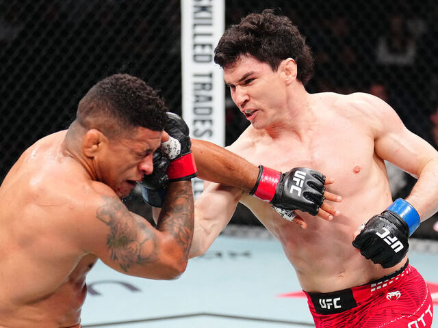WINNIPEG, MANITOBA - APRIL 18: (R-L) Mike Malott punches Gilbert Burns of Brazil in a welterweight fight during the UFC Fight Night event at Canada Life Centre on April 18, 2026 in Winnipeg, Manitoba.
