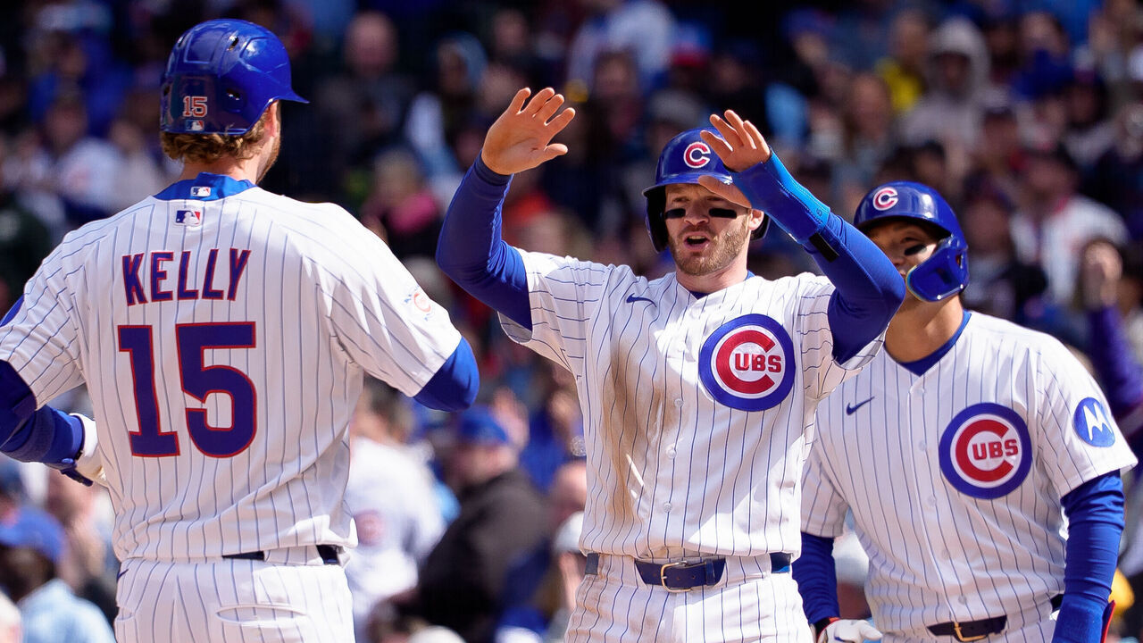 CHICAGO, ILLINOIS - APRIL 18: Ian Happ #8 celebrates a home run off the bat of Carson Kelly #15 of the Chicago Cubs in the sixth inning against the New York Mets at Wrigley Field on April 18, 2026 in Chicago, Illinois.