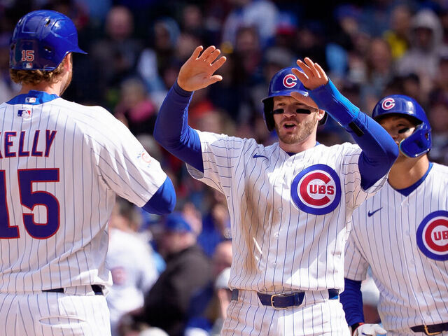 CHICAGO, ILLINOIS - APRIL 18: Ian Happ #8 celebrates a home run off the bat of Carson Kelly #15 of the Chicago Cubs in the sixth inning against the New York Mets at Wrigley Field on April 18, 2026 in Chicago, Illinois.
