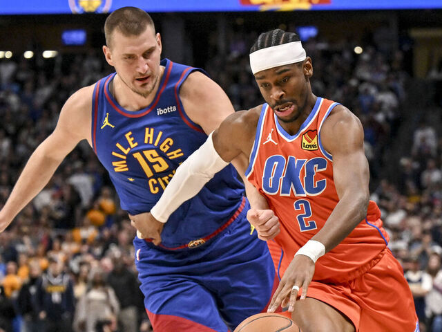 DENVER , CO - FEBRUARY 1: Nikola Jokic (15) of the Denver Nuggets defends Shai Gilgeous-Alexander (2) of the Oklahoma City Thunder during the first quarter at Ball Arena in Denver, Colorado on Sunday, February 1, 2026.