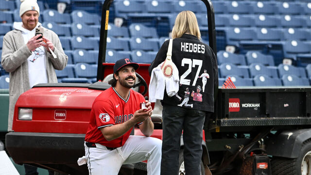 CLEVELAND, OHIO - APRIL 19: Austin Hedges #27 of the Cleveland Guardians proposes to his girlfriend Lexi Dickinson after the team's 8-4 win over the Baltimore Orioles at Progressive Field on April 19, 2026 in Cleveland, Ohio.