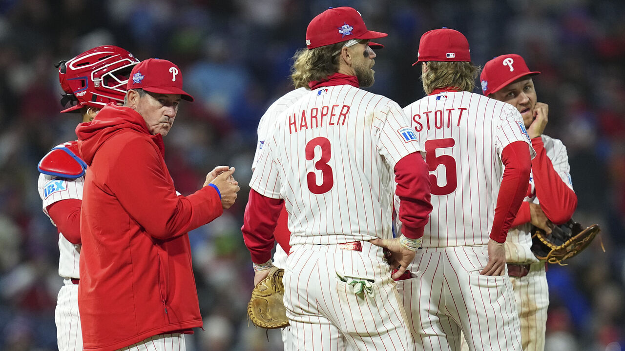 PHILADELPHIA, PENNSYLVANIA - APRIL 19: Rob Thomson #49, Rafael Marchán #13, Trea Turner #7, Bryson Stott #5, Alec Bohm #28, and Bryce Harper #3 of the Philadelphia Phillies look on against the Atlanta Braves at Citizens Bank Park on April 19, 2026 in Philadelphia, Pennsylvania. The Braves defeated the Phillies 4-2.