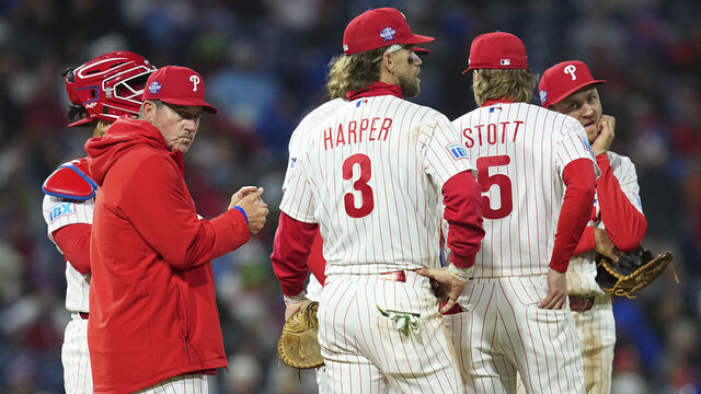 PHILADELPHIA, PENNSYLVANIA - APRIL 19: Rob Thomson #49, Rafael Marchán #13, Trea Turner #7, Bryson Stott #5, Alec Bohm #28, and Bryce Harper #3 of the Philadelphia Phillies look on against the Atlanta Braves at Citizens Bank Park on April 19, 2026 in Philadelphia, Pennsylvania. The Braves defeated the Phillies 4-2.