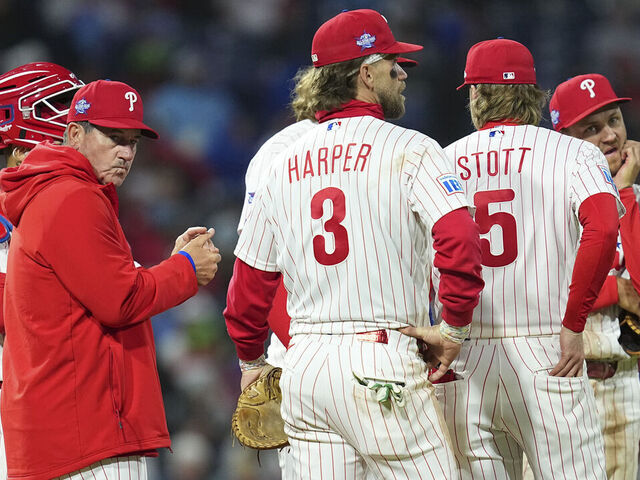 PHILADELPHIA, PENNSYLVANIA - APRIL 19: Rob Thomson #49, Rafael Marchán #13, Trea Turner #7, Bryson Stott #5, Alec Bohm #28, and Bryce Harper #3 of the Philadelphia Phillies look on against the Atlanta Braves at Citizens Bank Park on April 19, 2026 in Philadelphia, Pennsylvania. The Braves defeated the Phillies 4-2.