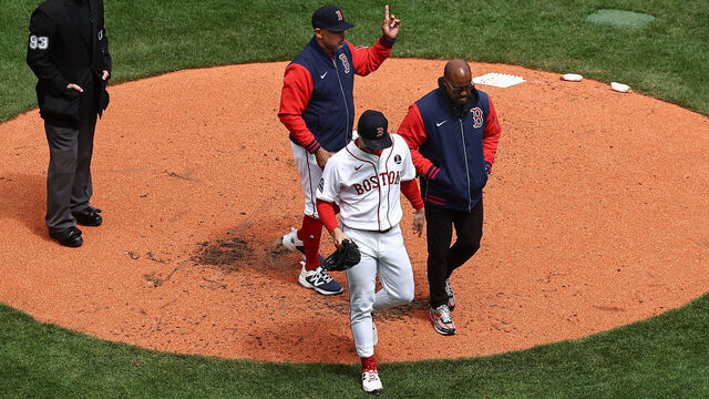 BOSTON, MA - APRIL 20: As manager Alex Cora #13 of the Boston Red Sox signals the bullpen for a pitcher, starting pitcher Sonny Gray #54 leaves the game with a trainer after being injured during the third inning against the Detroit Tigers at Fenway Park on April 20, 2026 in Boston, Massachusetts.