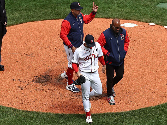 BOSTON, MA - APRIL 20: As manager Alex Cora #13 of the Boston Red Sox signals the bullpen for a pitcher, starting pitcher Sonny Gray #54 leaves the game with a trainer after being injured during the third inning against the Detroit Tigers at Fenway Park on April 20, 2026 in Boston, Massachusetts.