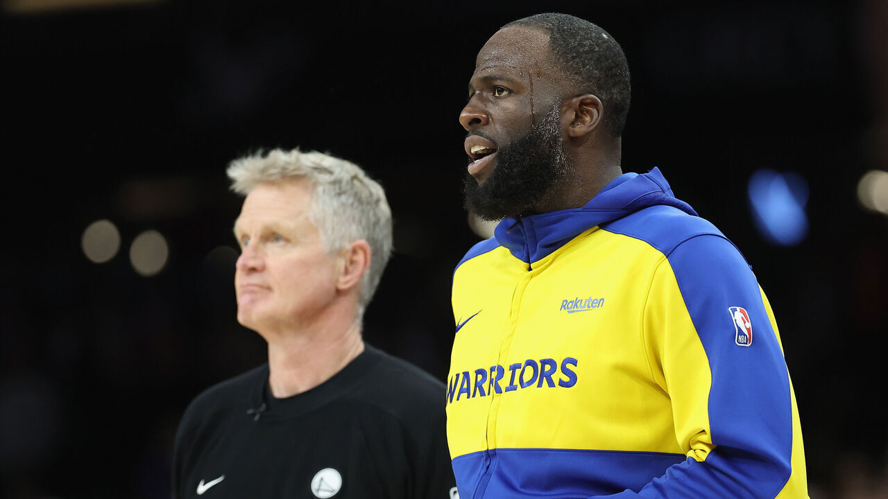 PHOENIX, ARIZONA - APRIL 17: Draymond Green #23 (R) of the Golden State Warriors stands with head coach Steve Kerr during the second half of an NBA play-in tournament game at Mortgage Matchup Center on April 17, 2026 in Phoenix, Arizona. The Suns defeated the Warriors 111-96.