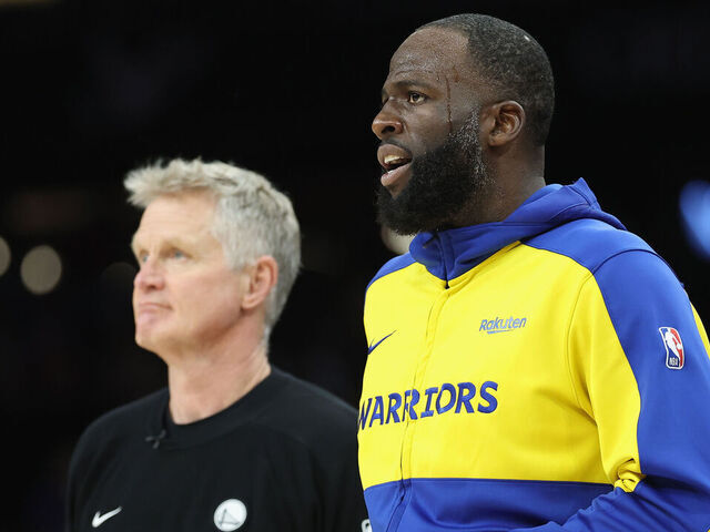 PHOENIX, ARIZONA - APRIL 17: Draymond Green #23 (R) of the Golden State Warriors stands with head coach Steve Kerr during the second half of an NBA play-in tournament game at Mortgage Matchup Center on April 17, 2026 in Phoenix, Arizona. The Suns defeated the Warriors 111-96.