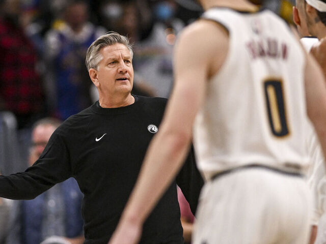 DENVER , CO - APRIL 18: Chris Finch of the Minnesota Timberwolves gets involved as Nikola Jokic (15) of the Denver Nuggets speaks to officials during the fourth quarter of the Nuggets' 116-105 win at Ball Arena in Denver, Colorado on Saturday, April 18, 2026. The Nuggets took a 1-0 lead in their best-of-seven series.