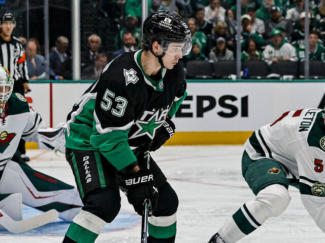 DALLAS, TX - APRIL 18: Dallas Stars center Wyatt Johnston (53) skates with the puck against Minnesota Wild defenseman Jake Middleton (5) during the Stanley Cup Playoffs First Round game 1 between the Dallas Stars and the Minnesota Wild on April 18, 2026 at American Airlines Center in Dallas, TX.