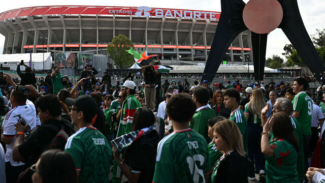 Demonstrators hold Palestine flags as Mexican fans arrive before the inauguration of Banorte Stadium (formerly known as Azteca), for a friendly match between Mexico and Portugal, in Mexico City on March 28, 2026.