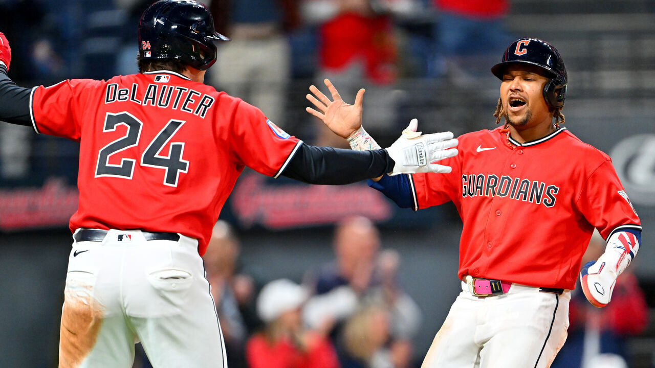 CLEVELAND, OHIO - APRIL 21: Chase DeLauter #24 and José Ramírez #11 of the Cleveland Guardians celebrate scoring during the eighth inning against the Houston Astros at Progressive Field on April 21, 2026 in Cleveland, Ohio. The Guardians defeated the Astros 5-8.