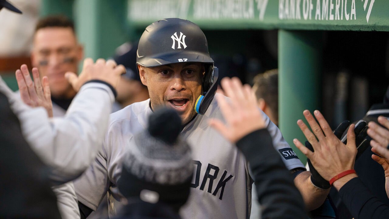 BOSTON, MA - APRIL 21: Giancarlo Stanton #27 of the New York Yankees celebrates with teammates in the dugout after hitting a solo home run in the second inning during the game between the New York Yankees and the Boston Red Sox at Fenway Park on Tuesday, April 21, 2026 in Boston, Massachusetts.