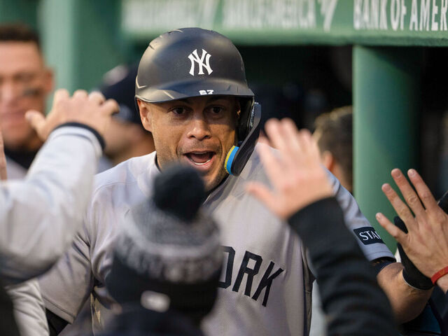 BOSTON, MA - APRIL 21: Giancarlo Stanton #27 of the New York Yankees celebrates with teammates in the dugout after hitting a solo home run in the second inning during the game between the New York Yankees and the Boston Red Sox at Fenway Park on Tuesday, April 21, 2026 in Boston, Massachusetts.