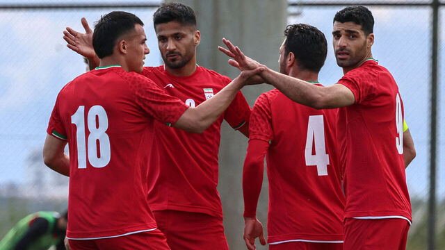 Iran's forward #18 Amirhossein Hosseinzadeh celebrates with his teammates after scoring a goal during a friendly football match between Iran and Costa Rica, in Antalya, southern Turkey, on March 31, 2026. FIFA's president told AFP that Iran "will be at the World Cup" despite the Middle East war.
