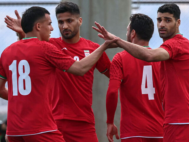 Iran's forward #18 Amirhossein Hosseinzadeh celebrates with his teammates after scoring a goal during a friendly football match between Iran and Costa Rica, in Antalya, southern Turkey, on March 31, 2026. FIFA's president told AFP that Iran "will be at the World Cup" despite the Middle East war.