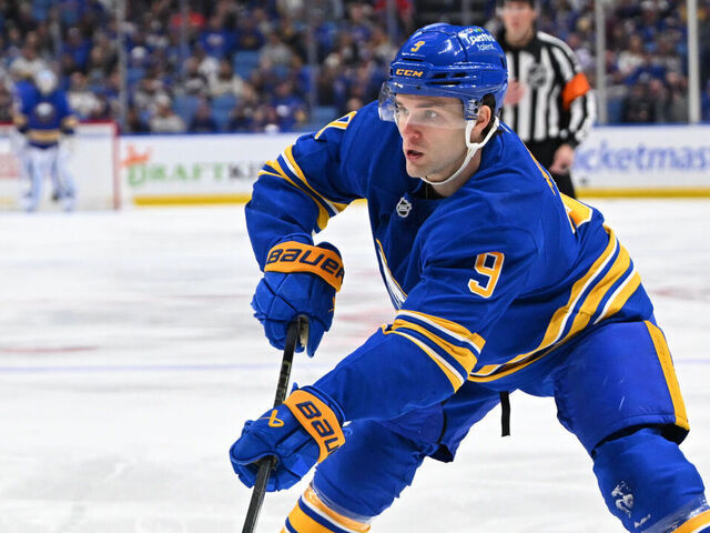 BUFFALO, NEW YORK - APRIL 19: Josh Norris #9 of the Buffalo Sabres passes the puck against Marat Khusnutdinov #92 of the Boston Bruins during Game One of the First Round of the 2026 Stanley Cup Playoffs at KeyBank Center on April 19, 2026 in Buffalo, New York.