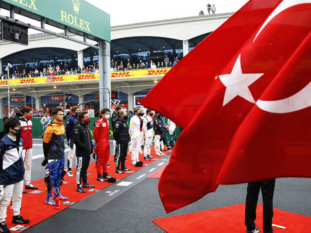 ISTANBUL, TURKEY - OCTOBER 10: The drivers stand for the national anthem on the grid during the F1 Grand Prix of Turkey at Intercity Istanbul Park on October 10, 2021 in Istanbul, Turkey.