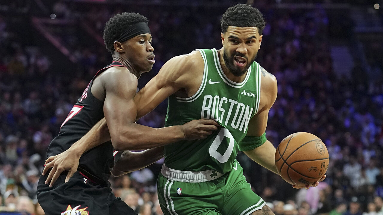 PHILADELPHIA, PENNSYLVANIA - APRIL 24: Jayson Tatum #0 of the Boston Celtics dribbles the ball against Vj Edgecombe #77 of the Philadelphia 76ers in the third quarter during game three of the Eastern Conference first round playoffs at Xfinity Mobile Arena on April 24, 2026 in Philadelphia, Pennsylvania. The Celtics defeated the 76ers 108-100.