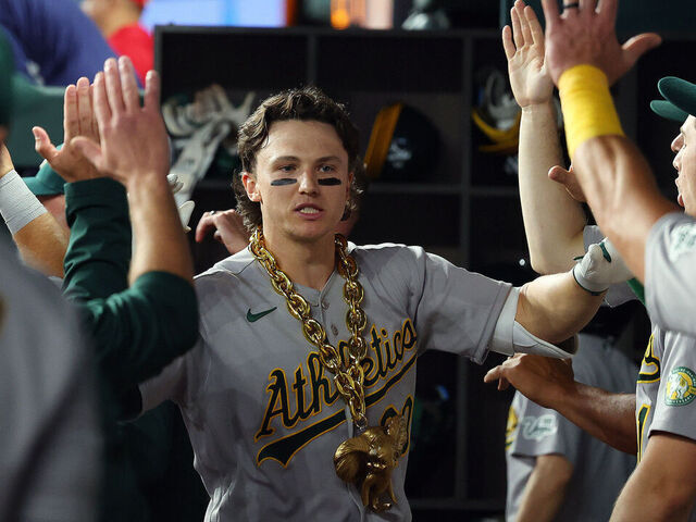 ARLINGTON, TEXAS - APRIL 24: Zack Gelof #20 of the Athletics is greeted in the dugout after hitting a two-run home run in the ninth inning against the Texas Rangers at Globe Life Field on April 24, 2026 in Arlington, Texas.