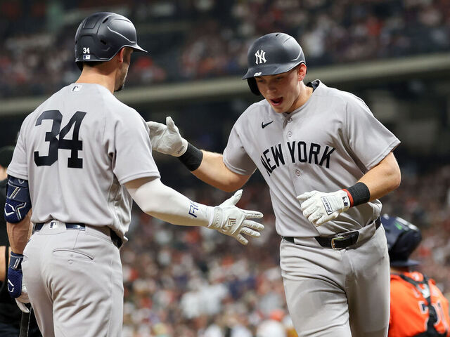 HOUSTON, TEXAS - APRIL 24: Ben Rice #22 of the New York Yankees is congratulated by Randal Grichuk #34 after a home run in the seventh inning against the Houston Astros at Daikin Park on April 24, 2026 in Houston, Texas.