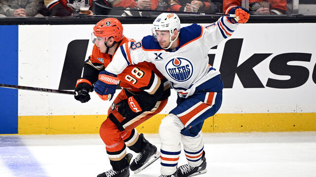 ANAHEIM, CA - APRIL 24: Anaheim Ducks defenseman Pavel Mintyukov (98) fights for position with Edmonton Oilers left wing Zach Hyman (18) during game 3 Stanley Cup Playoffs First Round game against the Oilers played on April 24, 2026 at the Honda Center in Anaheim, CA.