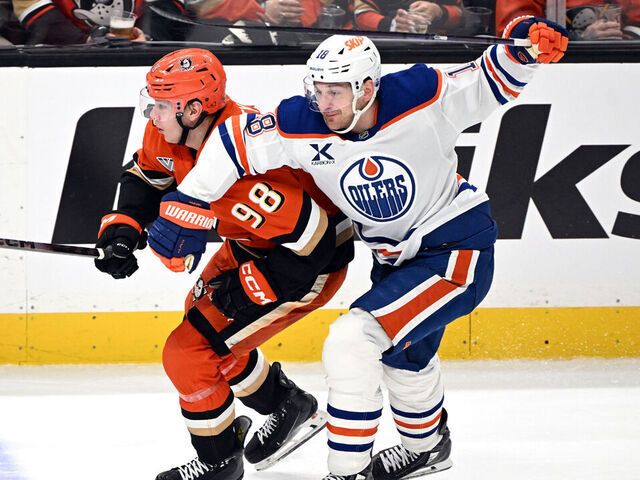ANAHEIM, CA - APRIL 24: Anaheim Ducks defenseman Pavel Mintyukov (98) fights for position with Edmonton Oilers left wing Zach Hyman (18) during game 3 Stanley Cup Playoffs First Round game against the Oilers played on April 24, 2026 at the Honda Center in Anaheim, CA.