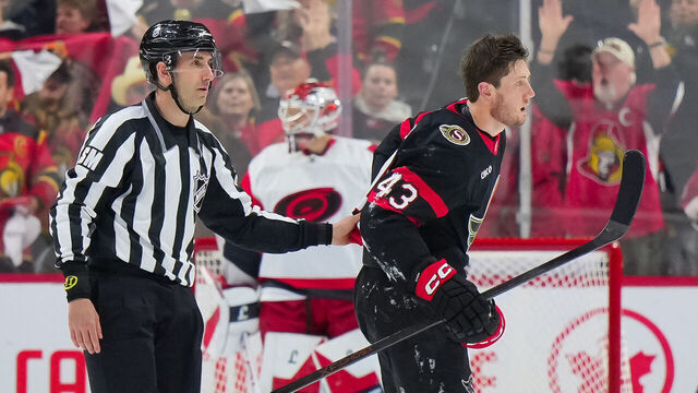 OTTAWA, CANADA - APRIL 25: Tyler Kleven #43 of the Ottawa Senators is escorted to his bench after body-checking Alexander Nikishin #21 (not pictured) of the Carolina Hurricanes during the second period in Game Four of the First Round of the 2026 Stanley Cup Playoffs at Canadian Tire Centre on April 25, 2026, in Ottawa, Ontario, Canada.