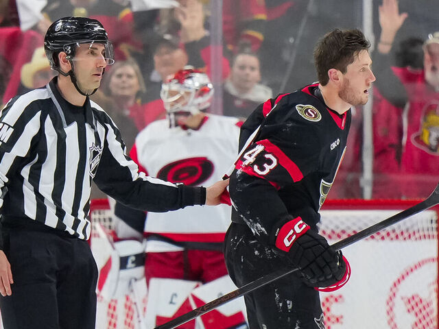 OTTAWA, CANADA - APRIL 25: Tyler Kleven #43 of the Ottawa Senators is escorted to his bench after body-checking Alexander Nikishin #21 (not pictured) of the Carolina Hurricanes during the second period in Game Four of the First Round of the 2026 Stanley Cup Playoffs at Canadian Tire Centre on April 25, 2026, in Ottawa, Ontario, Canada.