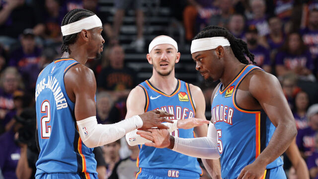 PHOENIX, AZ - APRIL 25: Shai Gilgeous-Alexander #2 and Luguentz Dort #5 of the Oklahoma City Thunder high five during the game against the Phoenix Suns during Round One Game Three of the 2026 NBA Playoffs on April 25, 2026 at PHX Arena in Phoenix, Arizona. Mandatory Copyright Notice: Copyright 2026 NBAE