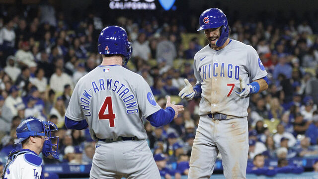 LOS ANGELES, CA - APRIL 24, 2026: Chicago Cubs shortstop Dansby Swanson (7) is congratulated at home plate by Chicago Cubs center fielder Pete Crow-Armstrong (4) after hitting the go-ahead 2-run homer off Los Angeles Dodgers pitcher Tanner Scott (66) in the ninth inning to give the Cubs the win at Dodger Stadium on April 24, 2026 in Los Angeles, CA. (Gina Ferazzi / Los Angeles Times via Getty Images)