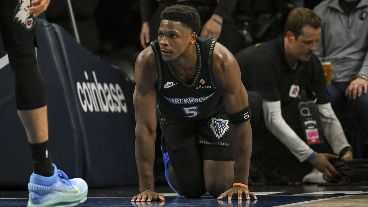 MINNEAPOLIS , MN - APRIL 25: Anthony Edwards (5) of the Minnesota Timberwolves crawls on the floor in pain after colliding with Cameron Johnson (23) of the Denver Nuggets during the second quarter of game four of their NBA Playoffs series at the Target Center in Minneapolis, Minnesota on Saturday, April 25, 2026. Edwards would leave the floor due to an apparent injury.