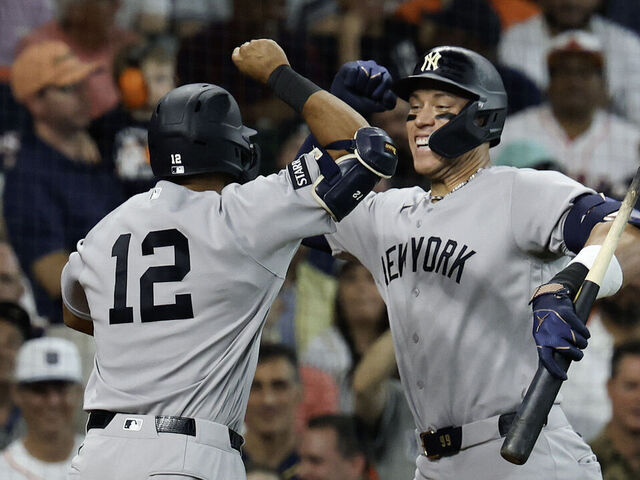 HOUSTON, TEXAS - APRIL 25: Trent Grisham #12 of the New York Yankees celebrates after hitting a solo homerun with Aaron Judge #99 during the second inning against the Houston Astros at Daikin Park on April 25, 2026 in Houston, Texas.