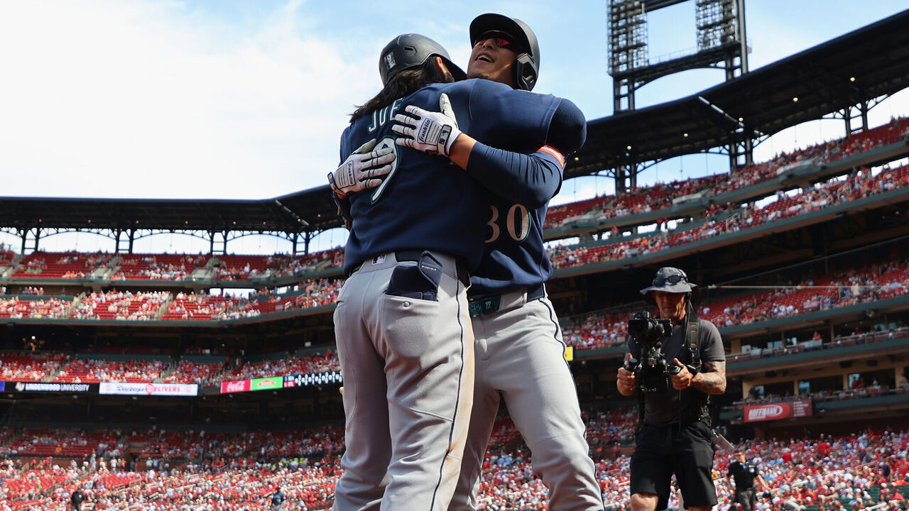 ST LOUIS, MISSOURI - APRIL 26: Rob Refsnyder #30 of the Seattle Mariners is congratulated by Connor Joe #9 of the Seattle Mariners after hitting a game-winning solo home run against the St. Louis Cardinals in the ninth inning at Busch Stadium on April 26, 2026 in St Louis, Missouri.