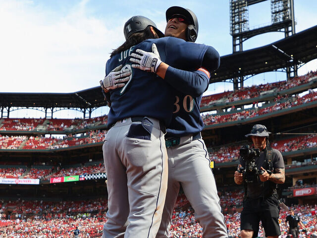 ST LOUIS, MISSOURI - APRIL 26: Rob Refsnyder #30 of the Seattle Mariners is congratulated by Connor Joe #9 of the Seattle Mariners after hitting a game-winning solo home run against the St. Louis Cardinals in the ninth inning at Busch Stadium on April 26, 2026 in St Louis, Missouri.
