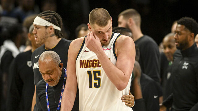 MINNEAPOLIS , MN - APRIL 25: Nikola Jokic (15) of the Denver Nuggets is pulled from a melee after he and Julius Randle (30) of the Minnesota Timberwolves engaged in a shoving match with a second to play during the fourth quarter of the Timberwolves' 112-96 win in game four of their NBA Playoffs series at the Target Center in Minneapolis, Minnesota on Saturday, April 25, 2026. Both Jokic and Randle were ejected as a result.