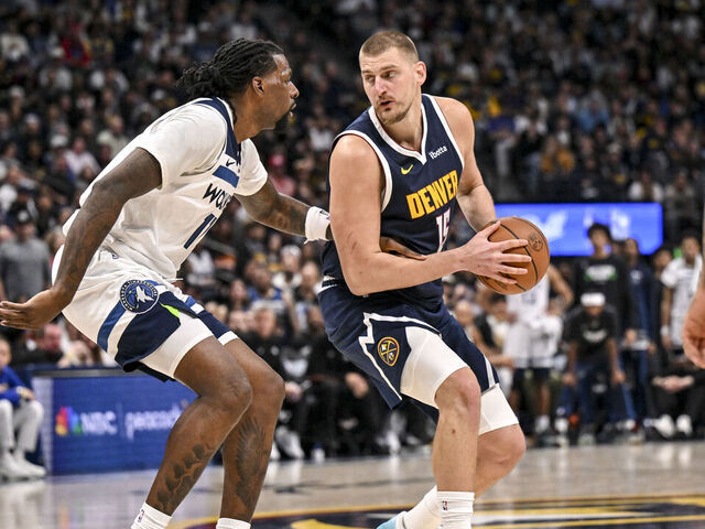 DENVER , CO - APRIL 27: Nikola Jokic (15) of the Denver Nuggets backs down Naz Reid (11) of the Minnesota Timberwolves during the fourth quarter of the Nuggets' 125-113 win in game five of their NBA Playoffs series on Monday, April 27, 2026. The Timberwolves lead 3-2 as they head back to Minneapolis for game six.