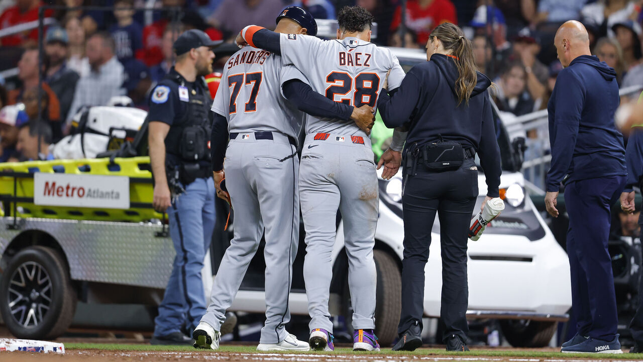 ATLANTA, GEORGIA - APRIL 28: Javier Baez #28 of the Detroit Tigers is helped to a cart after sustaining an injury during the fifth inning against the Atlanta Braves at Truist Park on April 28, 2026 in Atlanta, Georgia.